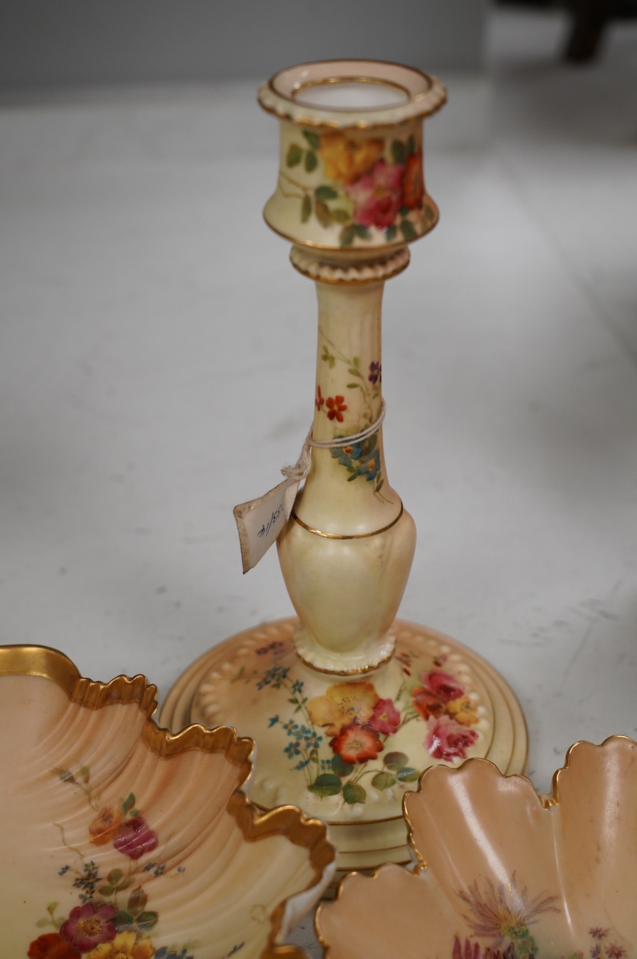 A pair of Royal Worcester blush ivory candlesticks, three bon bon dishes and a pair of plates, tallest 20cm. Condition - mostly good, some damage